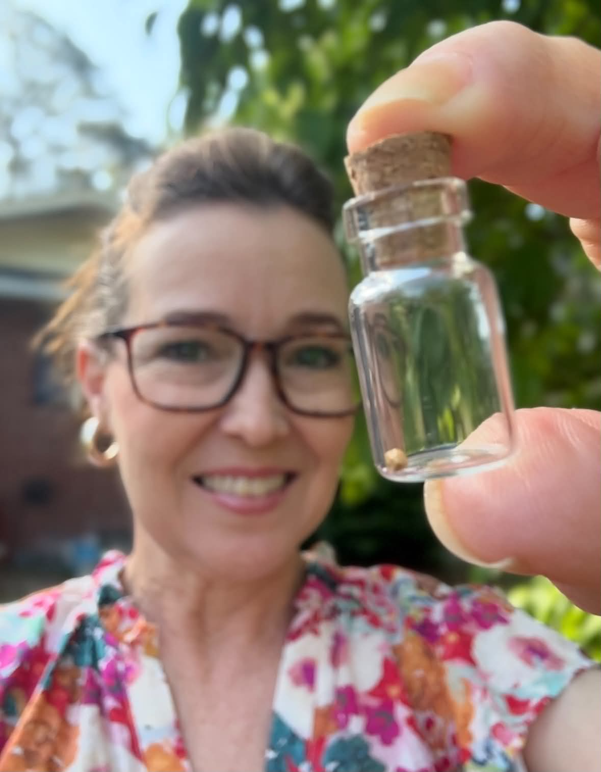 Founder holding a jar with a mustard seed